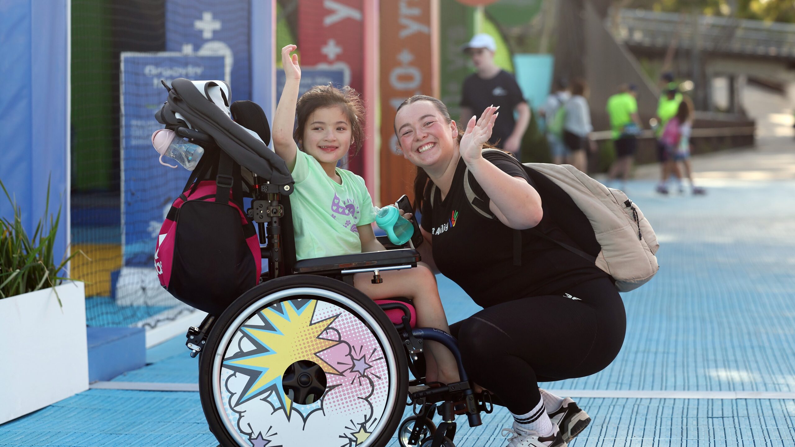 A child in a wheelchair at the Australian Open, enjoying the tennis.