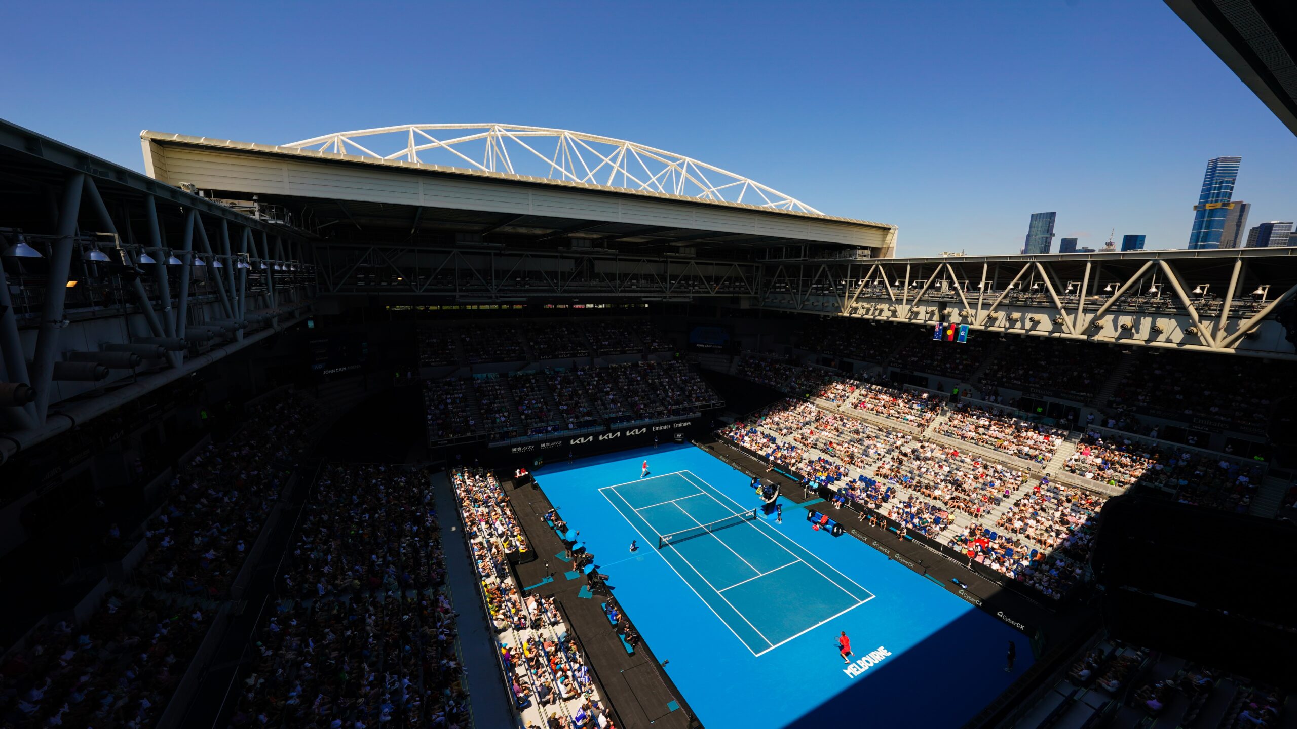 A tennis match in play in front of a crowd at the Australian Open.