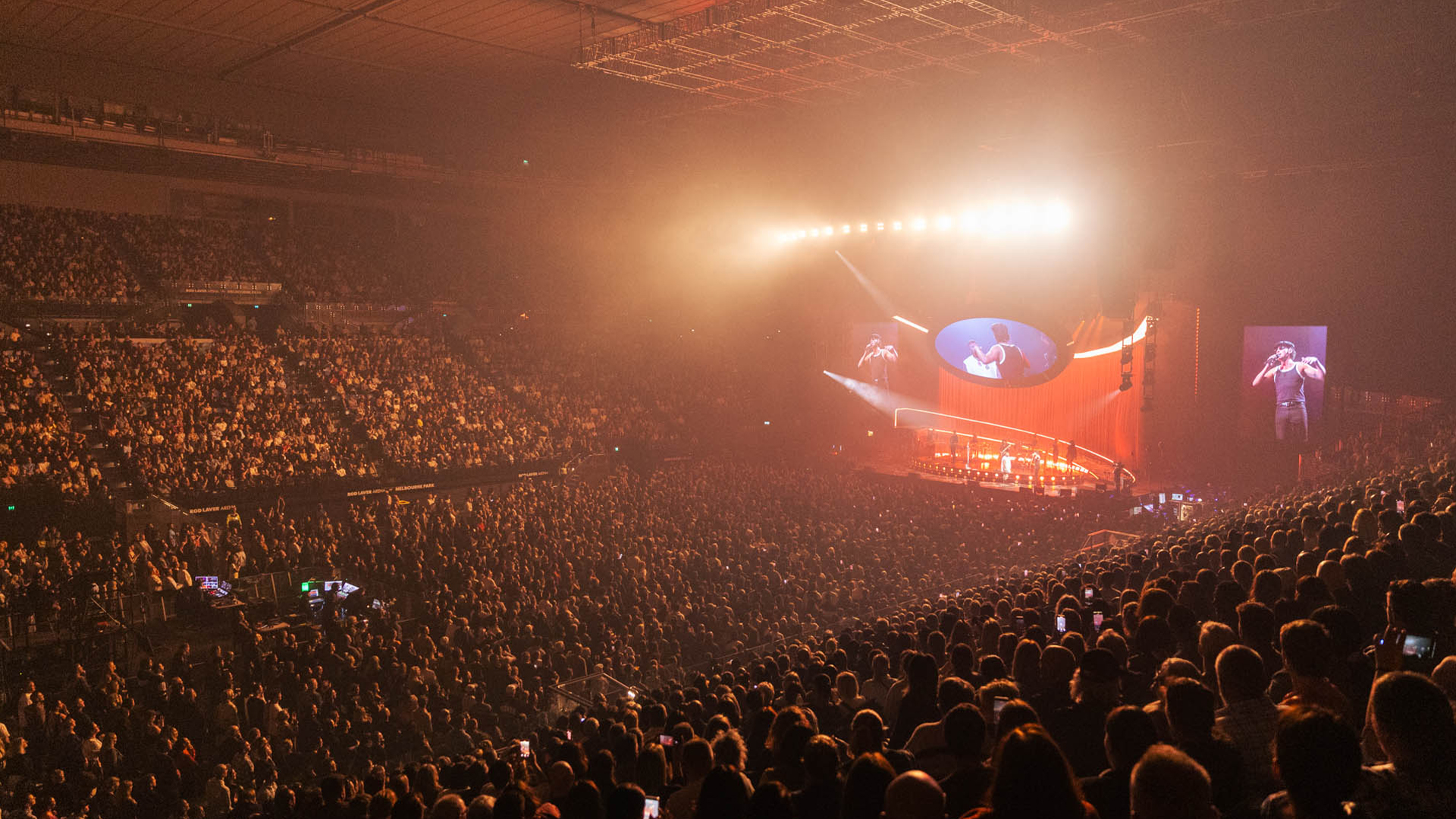 A packed crowd enjoying a concert at Rod Laver Arena.